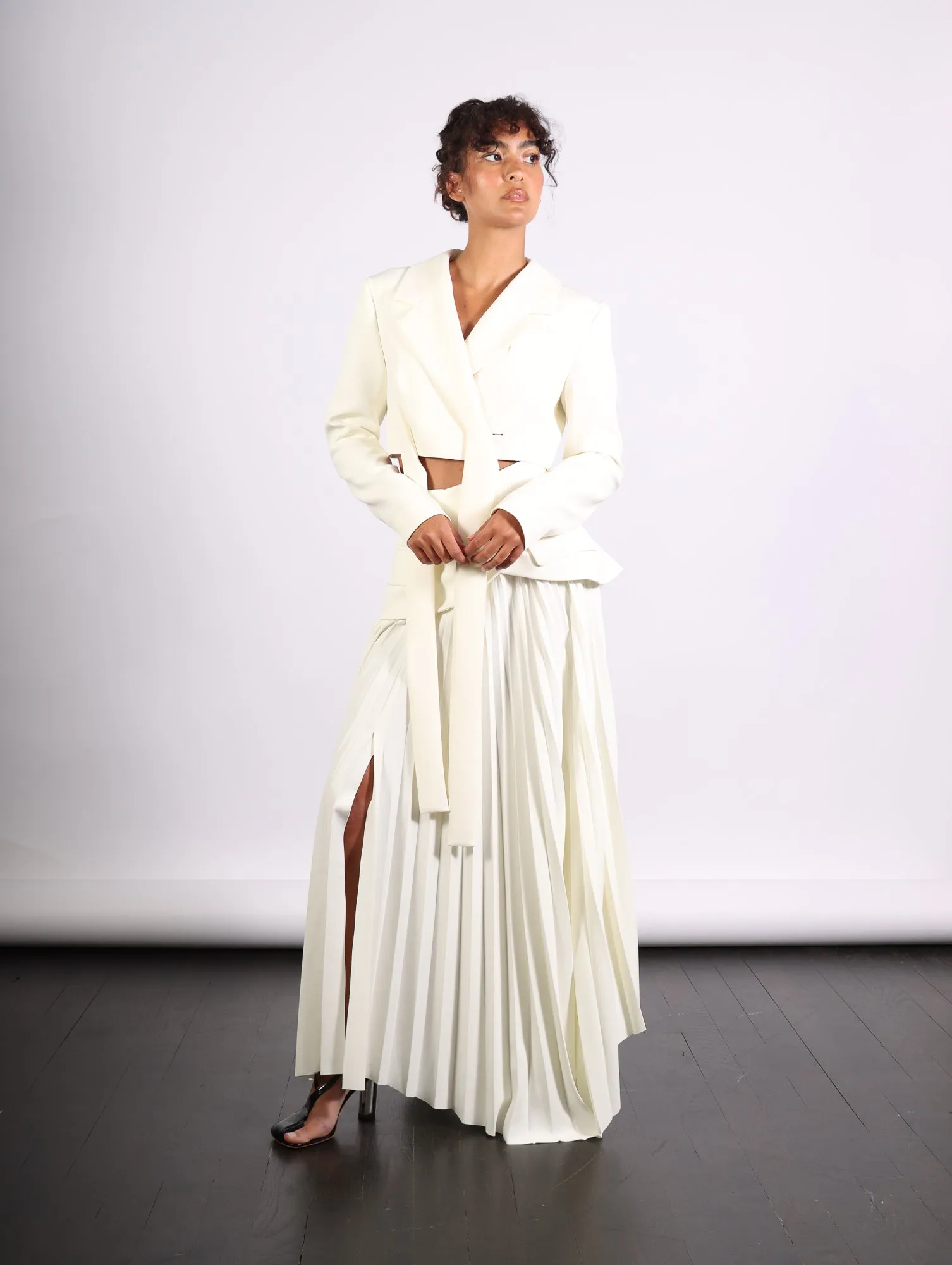Maxi Pleated Asymmetric Skirt in Ivory by A.W.A.K.E. Mode