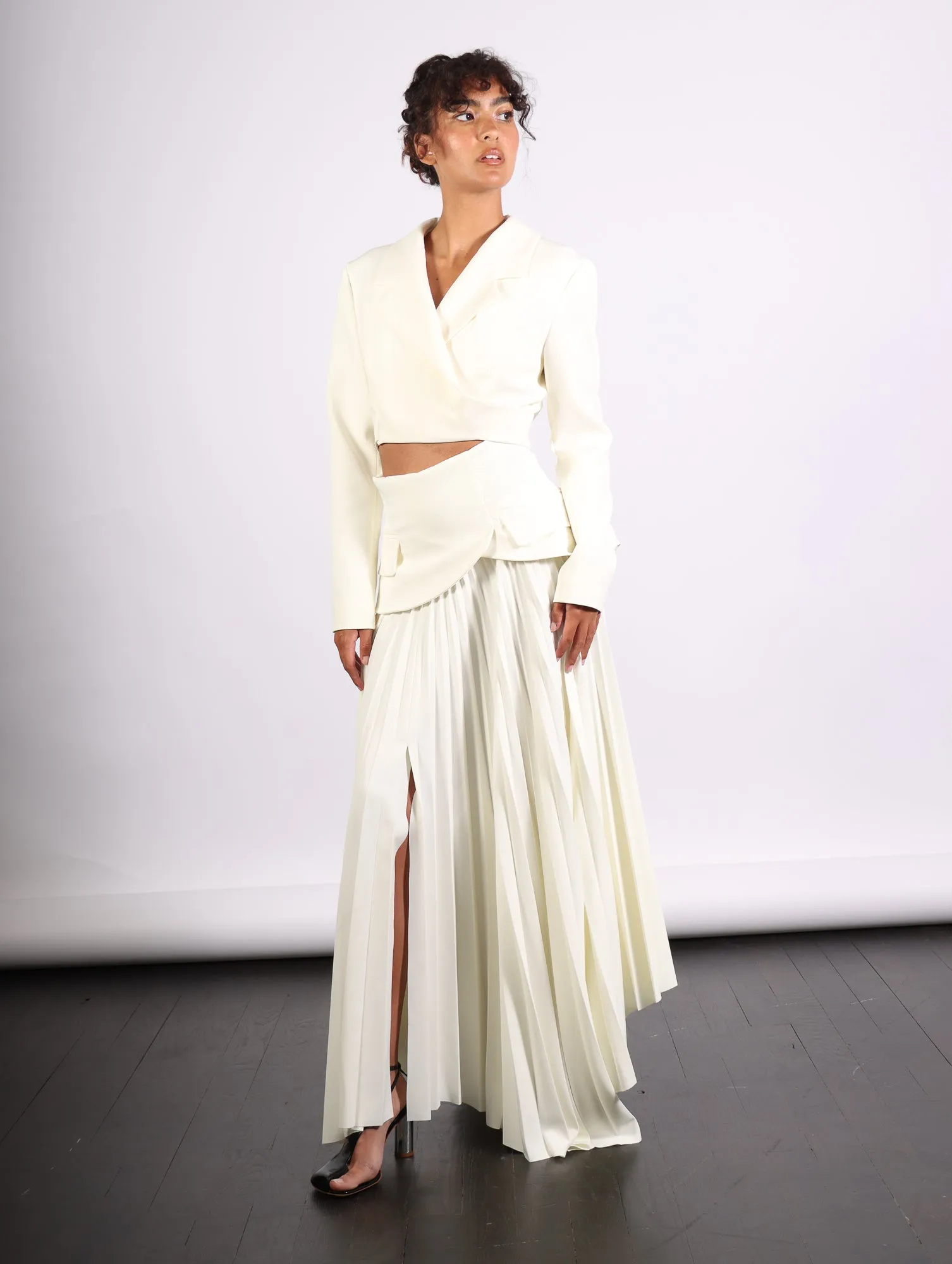 Maxi Pleated Asymmetric Skirt in Ivory by A.W.A.K.E. Mode
