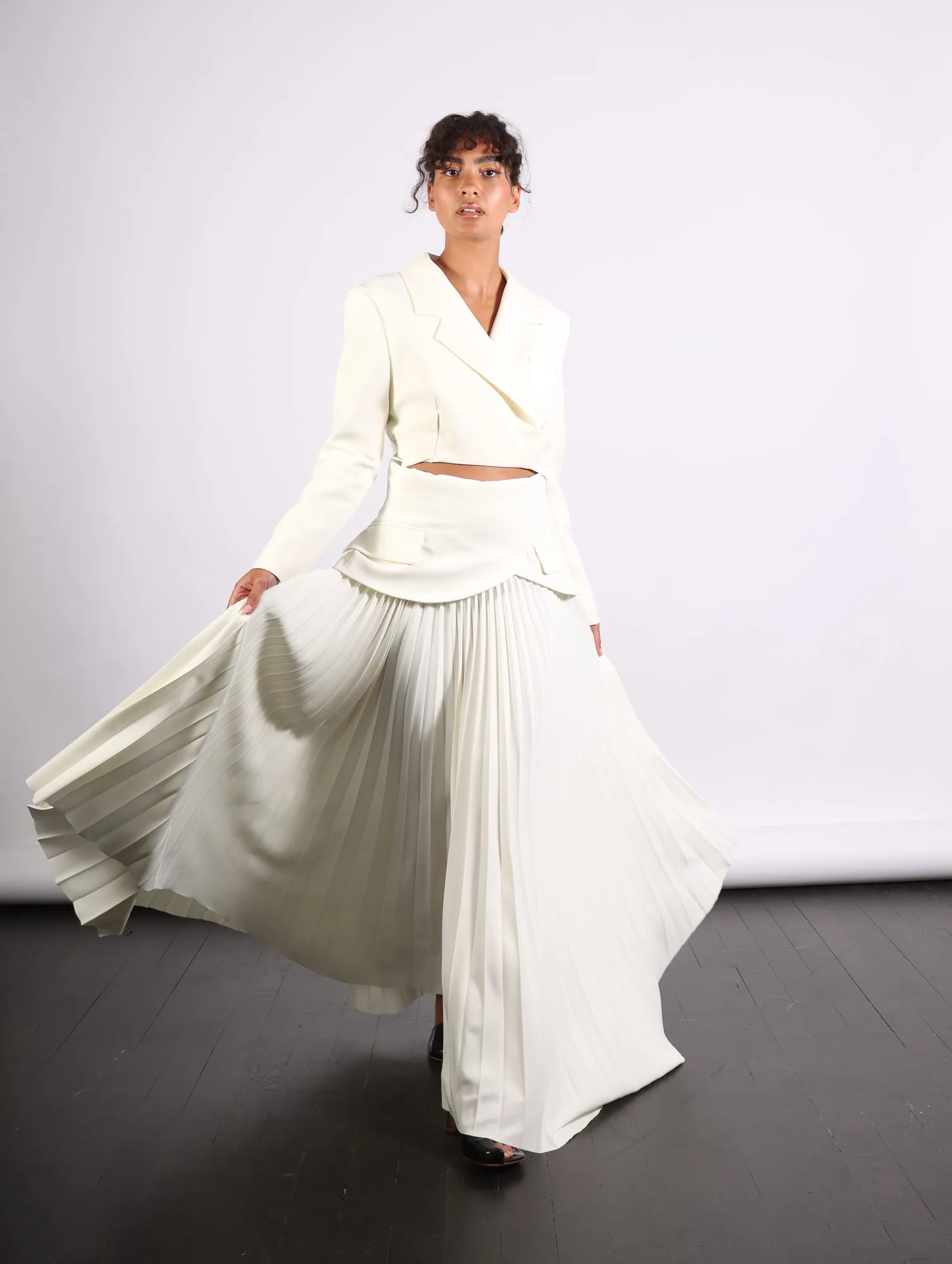 Maxi Pleated Asymmetric Skirt in Ivory by A.W.A.K.E. Mode