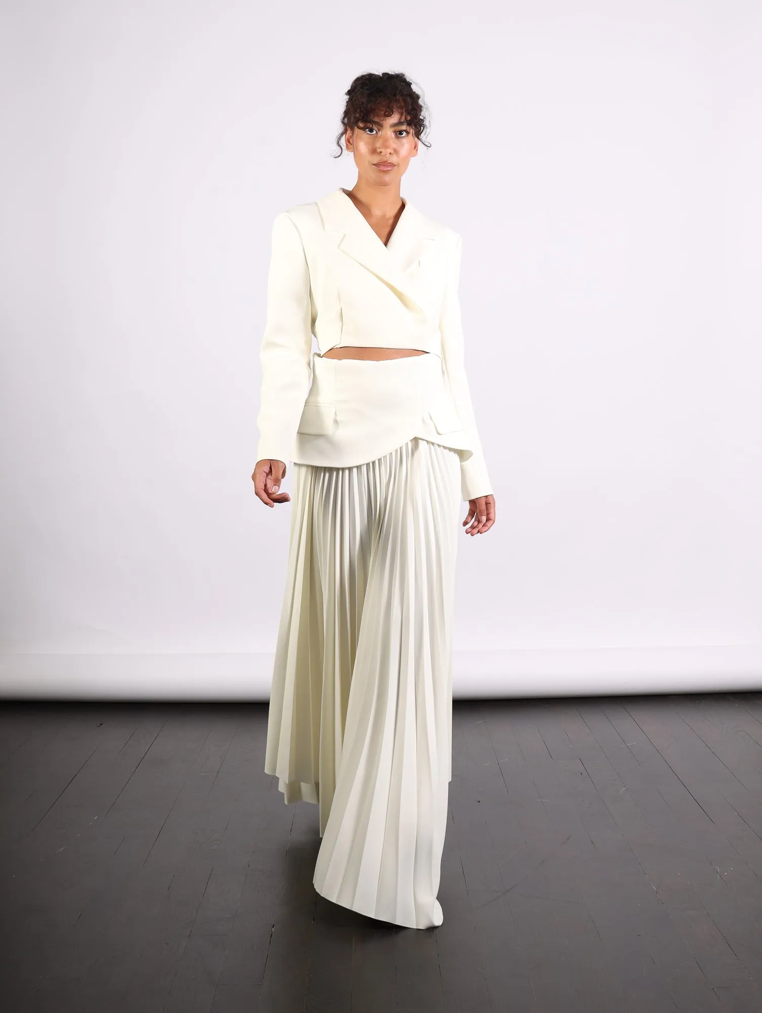Maxi Pleated Asymmetric Skirt in Ivory by A.W.A.K.E. Mode